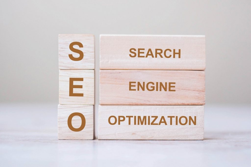 SEO (Search Engine Optimization) text wooden cube blocks on table background. Idea, Vision, Strategy, Analysis, Keyword and Content concept